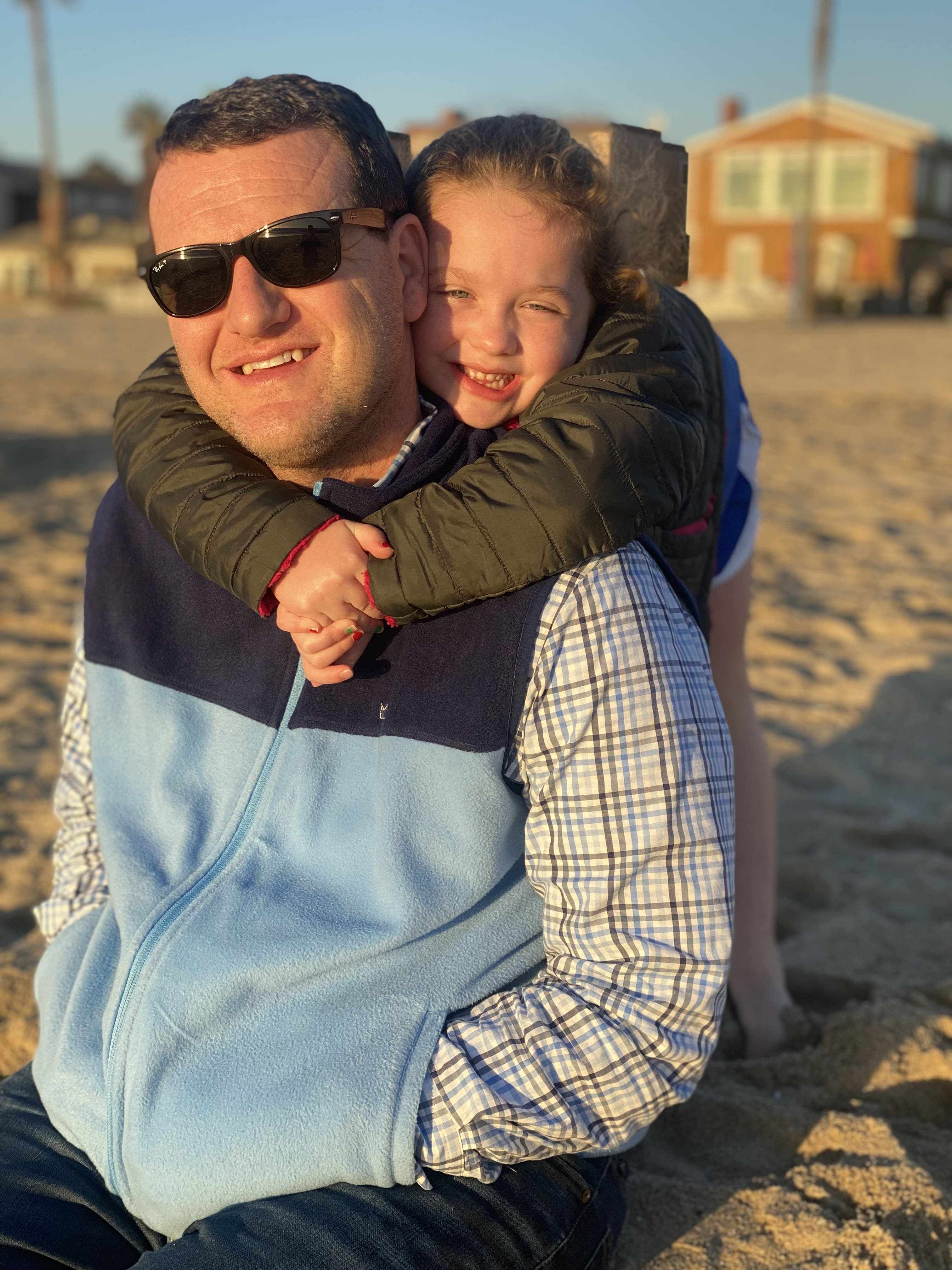 Michael and Ava on the beach—sunlit, unhurried time together.